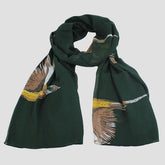 A green chiffon scarf with a pheasant design spread out on a plain surface.